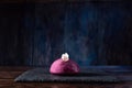 Pink pudding and white chocolate. Cakes on a tray. Sweets on display. Blue background.