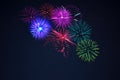 Pink purpe blue green fireworks over starry sky