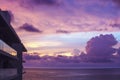 Pink and purple Caribbean sunset reflecting on the windows of a building