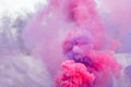 Pink and purple colored smoke bombs festival