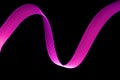 Pink and purple glow neon wave of light with smooth stripes on black background.