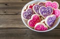 Pink and purple heart shaped cookies on wooden background