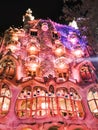 Pink and purple lighting of the walls of Casa Batllo in Barcelona at night