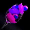 Pink and purple rubber ducks in wineglasses