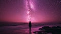 A pink and purple spacescape. Small silhouette of a human man on the background of the starry sky. Concept of infinity of the