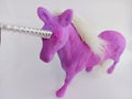 Pink and purple unicorn toy figure on a white background