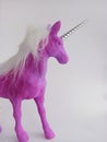 Pink and purple unicorn toy figure on a white background