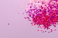 Pink, purple, violet, red glitter, sequins, confetti on bright background Royalty Free Stock Photo