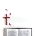 Flat lay: open Bible, wooden cross, book and pink, purple, violette, red Gerbera flower with petals Royalty Free Stock Photo