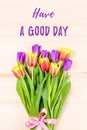 Pink, purple, yellow tulips on wooden background, flowers arrangement. Have a good day greeting card Royalty Free Stock Photo