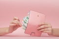 Pink purse and Euro banknotes in Female hands on pink background. Business Concept and Instagram Royalty Free Stock Photo