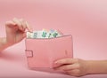 Pink purse and Euro banknotes in Female hands on pink background. Business Concept and Instagram Royalty Free Stock Photo