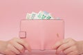 Pink purse and Euro banknotes in Female hands on pink background. Business Concept and Instagram Royalty Free Stock Photo