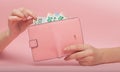 Pink purse and Euro banknotes in Female hands on pink background. Business Concept and Instagram Royalty Free Stock Photo