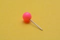 Pink pushpin isolated on a yellow background Royalty Free Stock Photo