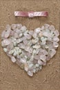 Pink quart and aquamarine crystals heart shape closeup on elegant white