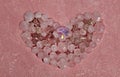 Pink quart crystals heart shape closeup on elegant peach background