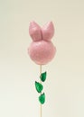 Pink rabbit head like a flower on a branch. Minimal Easter story