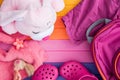 Pink rabbit, pink shoes, toys and pink bag on colorful background. Pink flat lay. Little girl room concept. Baby traveling concept Royalty Free Stock Photo