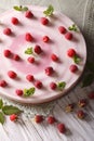 Pink raspberry cheese cake with fresh berries close-up. vertical Royalty Free Stock Photo