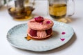 Pink Raspberry Macaron cookies on blue plate. Tea time. Blue table background. Royalty Free Stock Photo