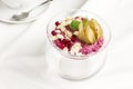Pink raw dessert mousse ice cream with berries and nuts in glass Royalty Free Stock Photo