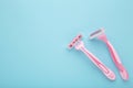 Pink razors for hair removal on blue background Royalty Free Stock Photo