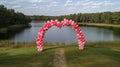 Pink and Red Balloon Arch by a Lake Royalty Free Stock Photo
