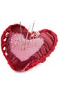 Pink and red heart shape with needles and thread isolated.