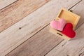 Pink and red hearts in tiny wooden treasure box. Minimal and simple love photo concept