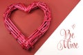 Pink red rattan cane love heart on red and white background with Be Mine message Royalty Free Stock Photo