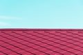Pink red roof top textured architecture with blue abstract background Royalty Free Stock Photo