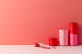 Pink and red sewing thread spools and measuring tape on coral background Royalty Free Stock Photo