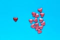 Pink and red small hearts on blue background. Abstract love, Valentine`s Day backdrop. Royalty Free Stock Photo