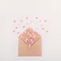 Pink, red and white sweets sugar candy hearts fly out of craft paper envelope on the white background . Valentine day concept. Gif Royalty Free Stock Photo