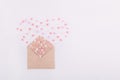 Pink, red and white sweets sugar candy hearts fly out in the form of heart from craft paper envelope on the white background . Val Royalty Free Stock Photo