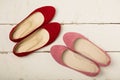 Pink and red women`s shoes ballerinas on wooden background. Royalty Free Stock Photo