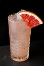 Pink refreshing drink with grapefruit in a glass of ice Royalty Free Stock Photo