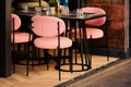 Pink restaurant chairs on steel frame in open terrace