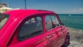 Pink retro car parked on pier in resort town, travel and vacation, summer time Royalty Free Stock Photo