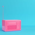 Pink retro styled radio on bright blue background in pastel colo Royalty Free Stock Photo