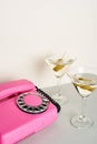 Pink retro telephone with martini cocktails Royalty Free Stock Photo