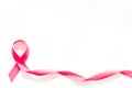 Pink ribbon as symbol of breast cancer awareness on white background top view copy space