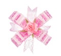 Pink ribbon bow with flower on white Royalty Free Stock Photo