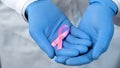 Pink ribbon in doctors hands, breast cancer awareness and prevention campaign Royalty Free Stock Photo