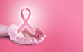 Pink ribbon on hands for breast cancer awareness Royalty Free Stock Photo