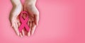 Pink ribbon on hands for breast cancer awareness Royalty Free Stock Photo