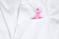 Pink ribbon inserted to the pocket of lab coat