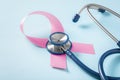 Pink ribbon with stethoscope on blue background, breast cancer awareness month Royalty Free Stock Photo