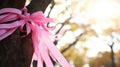 Pink ribbon on tree background. Breast Cancer Awareness concept. October Cancer Awareness Month. For poster, wallpaper Royalty Free Stock Photo
